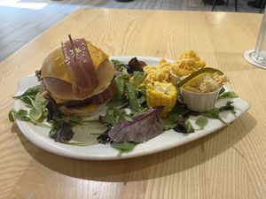 Burger with BBQ sauce, vegan cheese, vegan bacon, caramelized onions, corn, mac n cheese  at Lily Burger in Berlin