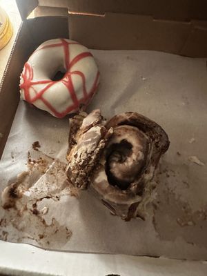 Cream cheese raspberry drizzle and a cinnamon roll  at Level 5 Donuts in Madison