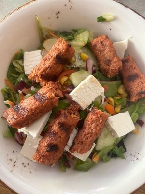 Salad with vegan cheese and vegan cevapcici at CeWapi in Ljubljana