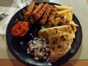 Vegan čevapčiči, onions, lepinja, ajvar, salad, fries at CeWapi in Ljubljana