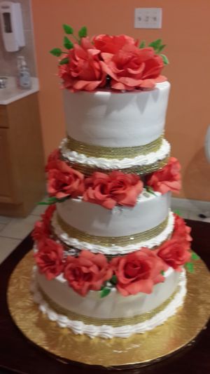 3 tier wedding cake with edible flowers at Rose Valley Cakes in Queens