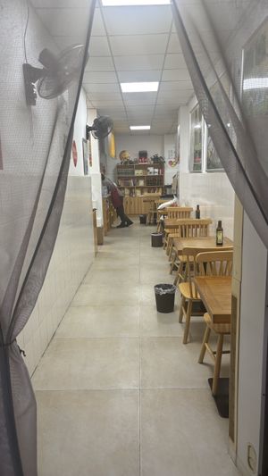 A few bigger tables in the back (half visible)  at Xiaobin Sushi in Chengdu
