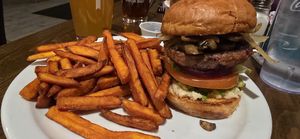 Vegan variation on The Blue Collar, substituted veggie burger, and avocado instead of blue cheese, added horseradish and sweet potato fries. at The Office Bar and Grill in Cheyenne