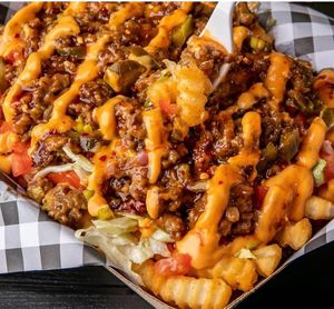 Pea protein top on of potato fries and our special sauce at Nature Heals Vegan Cafe in Boynton Beach