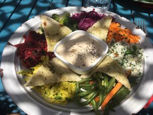 Mezze plate : vegetables and hummus in the center at House of Wonders in Cascais