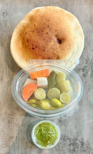 Bread, pickles and dips at Falafel Al Rabiah Al Khadhra - Al Taawun  in Sharjah