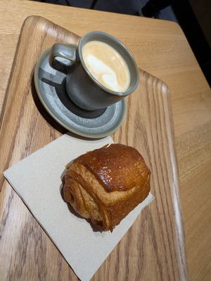 Pain au chocolate and cappuccino prepared wit oat milk at Land & Monkeys - Grands Boulevards in Paris
