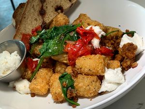 Tot+Sausage Hash: Tater Tots, Chickpea Sausage, Spinach, Red Onions, Vegan Goat Cheese, Mama Lil's Peppers, Cinnamon Raisin Toast, Vegan Butter, House-Made Jam at FiKA in Grand Rapids