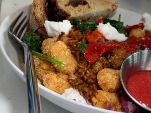 Tot + Sausage Hash: Tater Tots, Chickpea Sausage, Spinach, Red Onions, House-Made Goat Cheeze, Mama's Li'l Peppers, Cinnamon Raisin Toast at FiKA in Grand Rapids