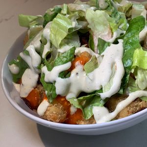 Buffalo Tots: Crispy Tots tossed in Buffalo Sauce, Coconut Bacon Bits, Lettuce, Green Onions, House-Made Ranch at FiKA in Grand Rapids