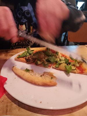 Grating the extra cheese we ordered... :D at Vegan Pizza Bar  in Utrecht