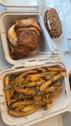 Croissant sandwich (with vegan egg and bacon), garlic cheese fries, and oatmeal crème pie (supplied by Flour + Time)  at Mission Burger Co. in Atlanta