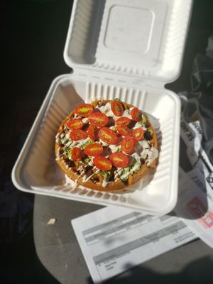 Savory pesto waffle with cashew cream and tomatoes at NW Raw in Ashland