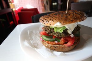 Black bean burger with vegetables, vegan mayo and kiwi. at miXtura in Poznan