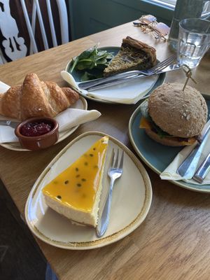 Spinach quiche, croissant, passion fruit cheese cake, pulled & spicy mushrooms sandwich   at Koffie ende Koeck in Amsterdam