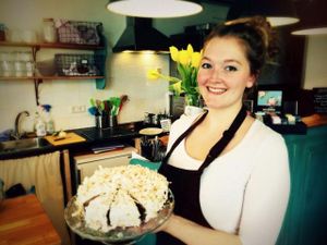 Owner with coconut cake  at Koffie ende Koeck in Amsterdam