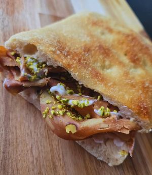 Pistracchio: vegetable mortadella, stracchetto cheese, chopped pistachios, and pistachio pesto at Focacceria Cecino in Milan