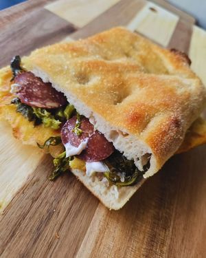 Cecino Peperino: chickpea flatbread, smoked stracchino cheese, spicy vegan salami, and broccoli rabe at Focacceria Cecino in Milan