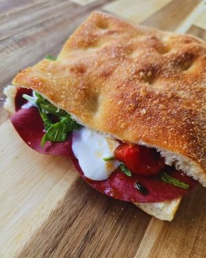 Feta Morgana: plant-based bresaola and feta cream, pan-caramelized cherry tomatoes, and arugula at Focacceria Cecino in Milan