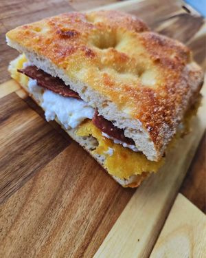 Cecino al Vesuvio: chickpea farinata, vegan ricotta cheese, spicy vegan salami, and black pepper at Focacceria Cecino in Milan