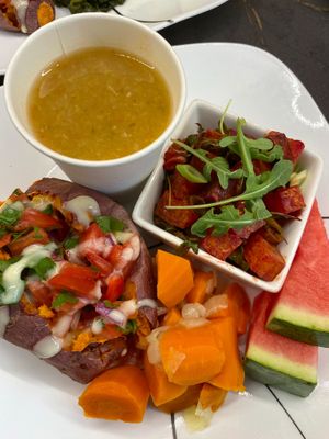 Gerson style sweet potato with pico and cilantro lime creme. Served with beet salad with an orange vinaigrette and stewed carrots and onions, Hippocrates soup and some watermelon.  at Ian and Angela in Sedona