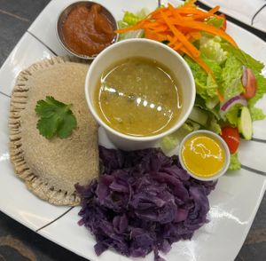 Empanada with marinara, sweet and sour cabbage, a green salad with our special house dressing and roasted fennel soup. at Ian and Angela in Sedona
