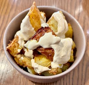 Spicy potatoes with tahini sauce  at The Larder  in Dubai