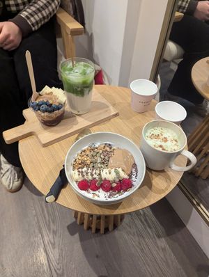 Yoghurt bowl and gingerbread matcha, mini acai bowl in background at ORA Wellness Cafe in Norwich