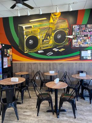 Indoor seating and wall mural at Rhythm 'n Wraps in Boston