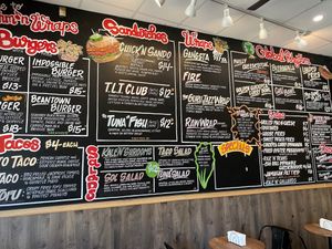 Vibrantly painted wall menu at Rhythm 'n Wraps in Boston