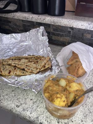 Potato stir fry with cauliflower, vegetable samosa & naan 🫓💌  at Garnish Indian Restaurant in Windhoek