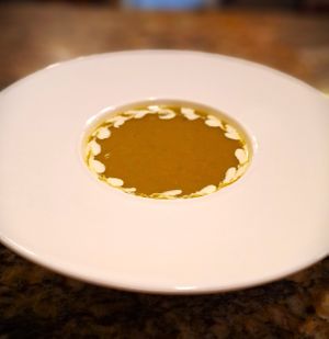 Asparagus Bisque garnished with lentil-based cream at Mondano in Old Forge