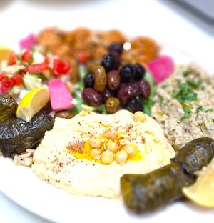 Mediterranean Mezze Plate (house-made hummus, baba ghanouj, muhammara, falafel, tahini sauce, and dolmadas) at Mondano in Old Forge