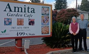 Owners YC and Jia-hwa in front of their sign at Amita Garden in Ukiah