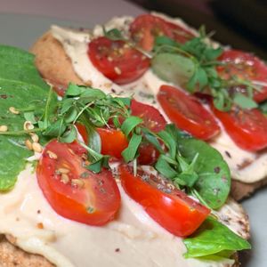 Hummus Toast: Ithaca Hummus, Za'atar Tomatoes, Olive Oil, Micro-Cilantro, Sub Vegan Bread at Matchacita in Kalamazoo