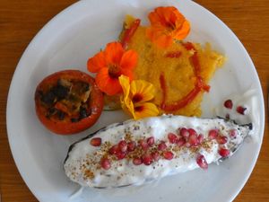 non-vegan egglant with fresh cheese - pomegranate filling, gomasio, polenta pizza (vegan), tomato filled with seitan, olives, gomasio  at Omassim in Santo Isidoro
