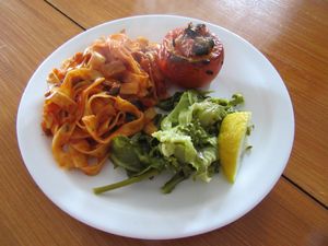 Vegan - tagliatelle with spicy tomato-olive sauce, filled tomato with seitan & olives  at Omassim in Santo Isidoro