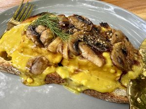 TOFU
BENEDICT: 
A twist on the classic,
Sourdough toast topped with pan fried seasoned tofu squares topped with sauteed garlic mushrooms, dolloped with hollandaise sauce.  at Firefly Specialty Coffee in Ubud