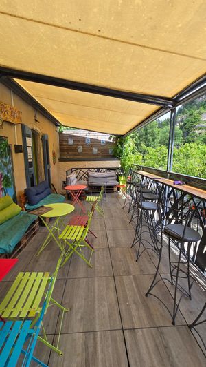 Outdoor seating looking at the river at l'Abracada bar in Gorges Du Tarn Causses