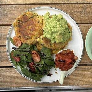 Corn fritters with smashed avocado and shakshuka beans  at 99 Shades Of Green  in Perth