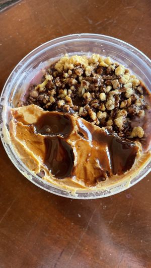 My custom toppings: crunchy sugar-free granola, peanut butter, and vegan chocolate sauce.  at Smoothie House  in Atenas