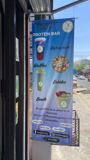 Their banner outside with a partial menu.  at Smoothie House  in Atenas