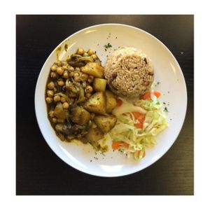 Caribbean Curry with rice and peas accompanied by steamed veggies  at Avocado Vegan Cafe in Alpharetta