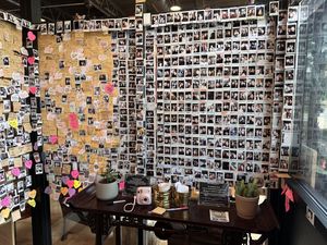 They let every new customer have one free photo to put on the wall  at Momo Cafe in Minneapolis