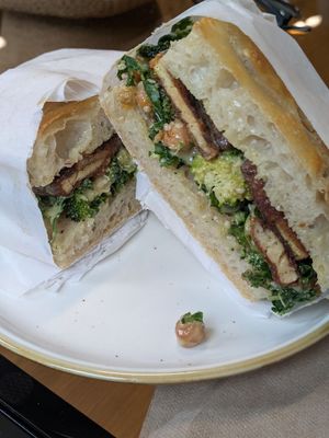 Tofu burger. Broccoli, kale, roast chickpeas, blackened tofu, on foccacia with a delightful mustard dressing. at Sevens in Buffalo