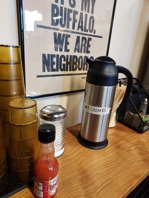 Self-serve oat creamer by the water station. at Sevens in Buffalo