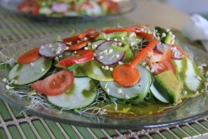 Tasty salad with piece of onion flat bread at Beauty of Sprouts. at Beauty of Sprouts in Sarasota