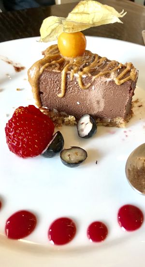 raw chocolate torte with delicious ripe tomatillo on top (partly eaten already!) at 222 Vegan Cuisine in West London