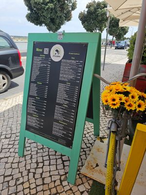 The menu (you can see the lagoon across the narrow road) at Restaurante A Cozinha in Praia De Mira
