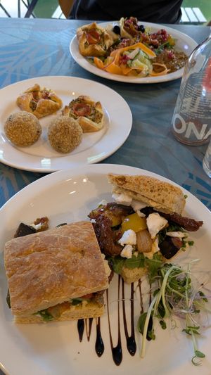 Mediterranean focaccia, arancini balls and savoury pastries (almond feta, spinach and tomato tart) at Planted Community Cafe, Refillery and Hub in Cheltenham